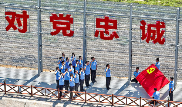 图二：参加主题党日活动民警在派出所“忠诚墙”下重温入党誓词。.jpg